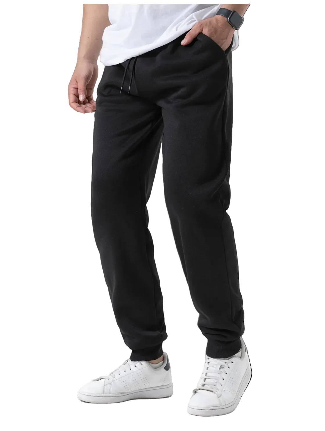Person wearing black jogger pants and white sneakers on a white background